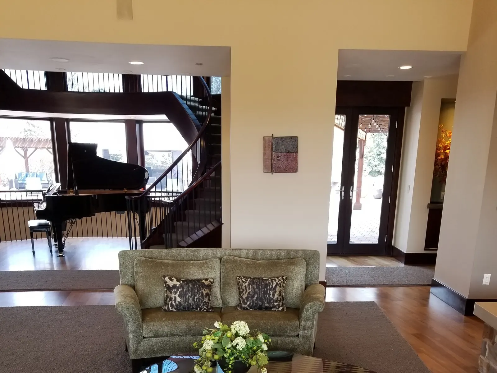 Spotless living room with grand piano after an L&G whole-home cleaning
