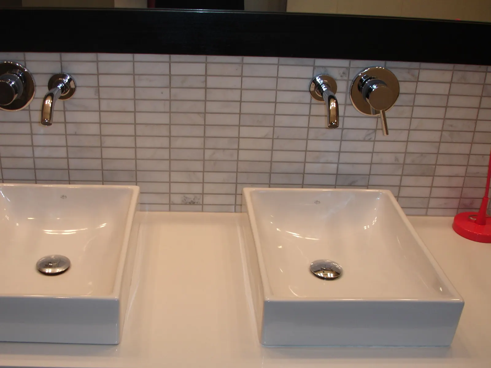 Polished double-sink bathroom with marble tile backsplash after cleaning