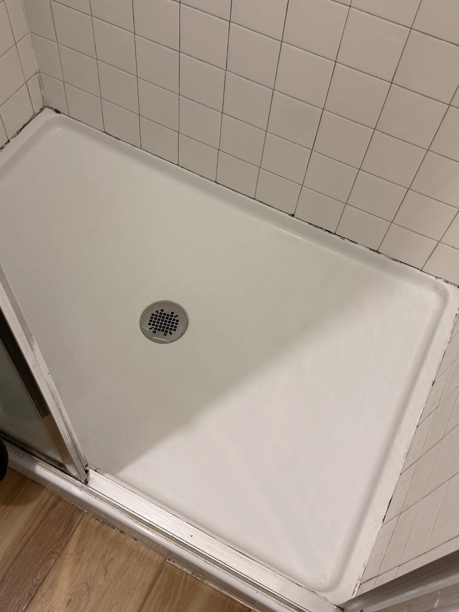 Shower pan spotless and restored after L&G Cleaning's deep clean